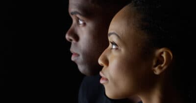 Dramatic profile of Black man and woman looking up